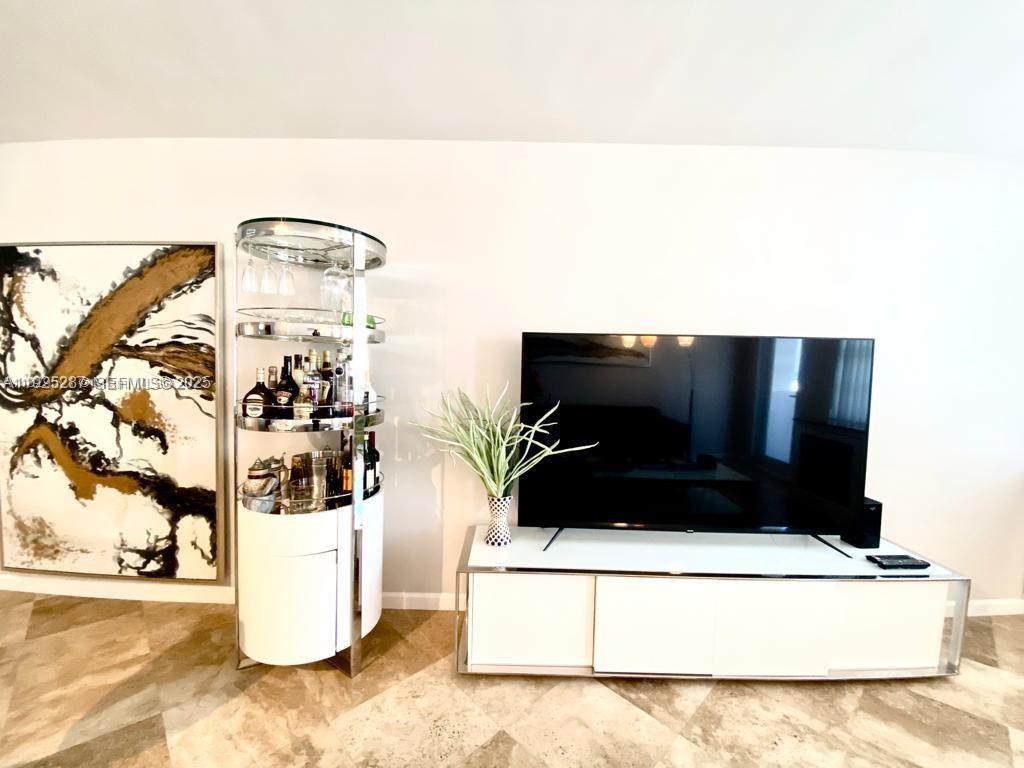 100 Lincoln Road, Unit 608 Miami Beach, FL 33139 - Photo 4 of 20 a living room with a couch and a table