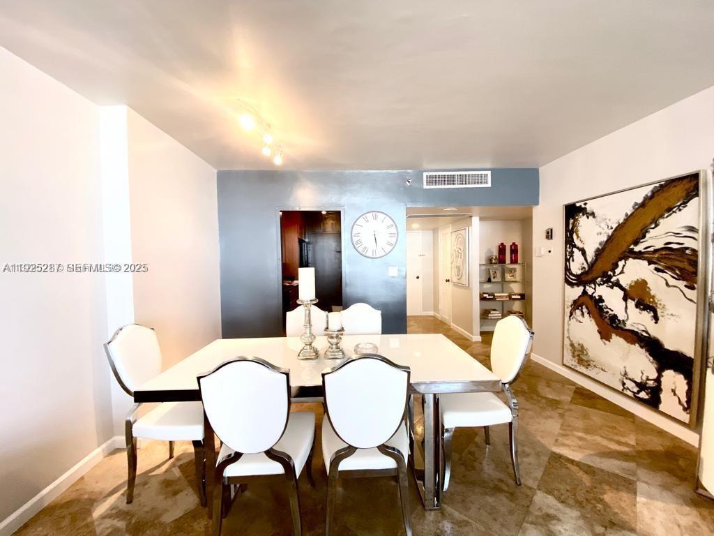 100 Lincoln Road, Unit 608 Miami Beach, FL 33139 - Photo 5 of 20 a view of a dining room with furniture and wooden floor