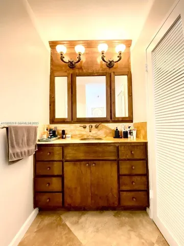a bathroom with a sink vanity and a mirror