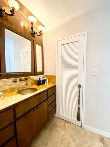 a bathroom with a double vanity sink and mirror