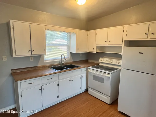 a kitchen with appliances cabinets and a sink