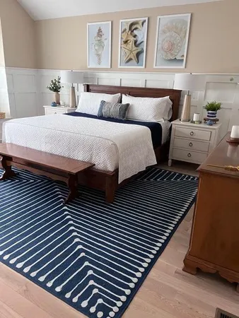 a bedroom with two beds and paintings on the wall