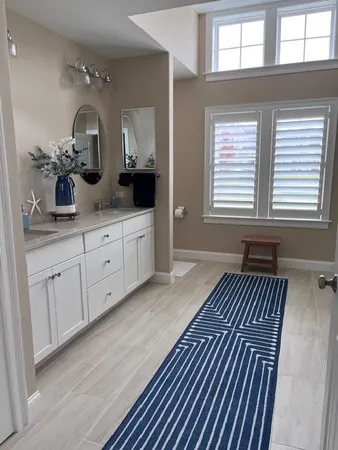 a spacious bathroom with a mirror and shower