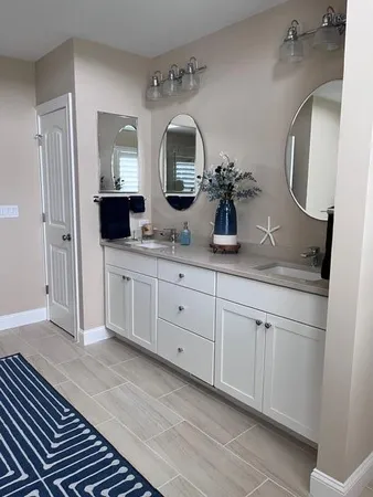 a bathroom with a double vanity sink and a mirror