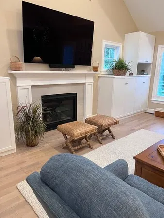 a living room with furniture and a fireplace
