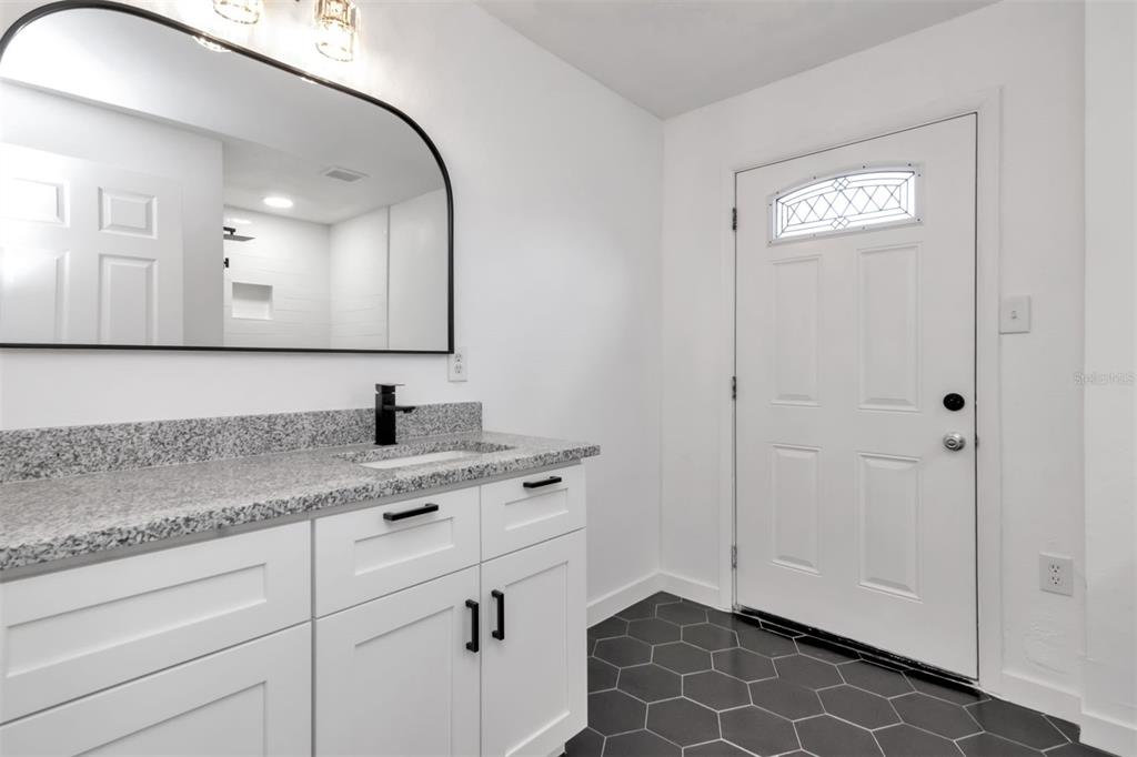 7148 Ramor Lane New Port Richey, FL 34653 - Photo 15 of 26 a bathroom with a double vanity sink mirror and