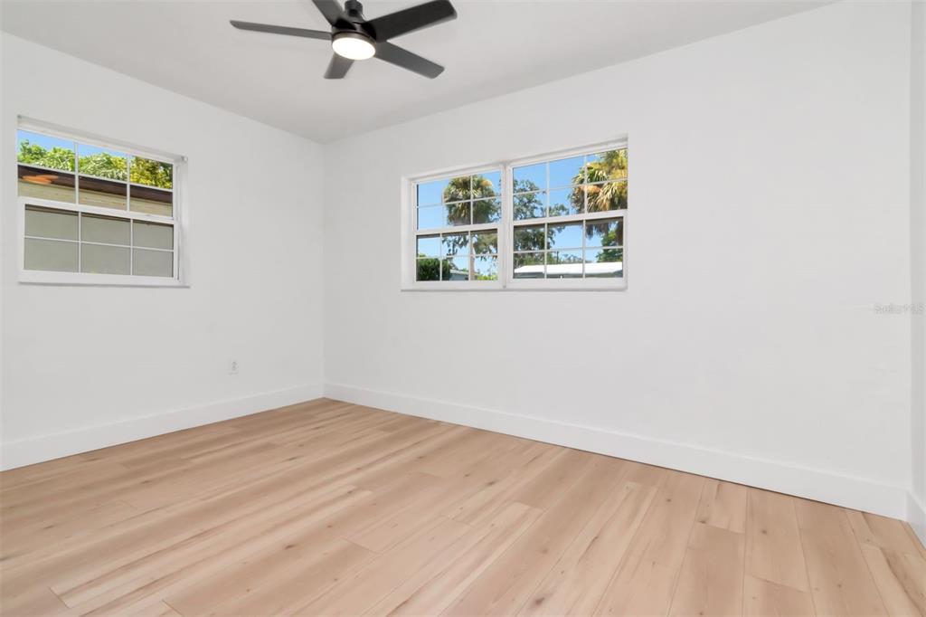7148 Ramor Lane New Port Richey, FL 34653 - Photo 16 of 26 a view of a livingroom with wooden floor and a ceiling fan