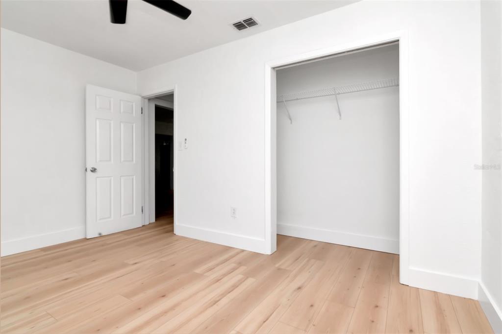 7148 Ramor Lane New Port Richey, FL 34653 - Photo 17 of 26 an empty room with wooden floor and windows