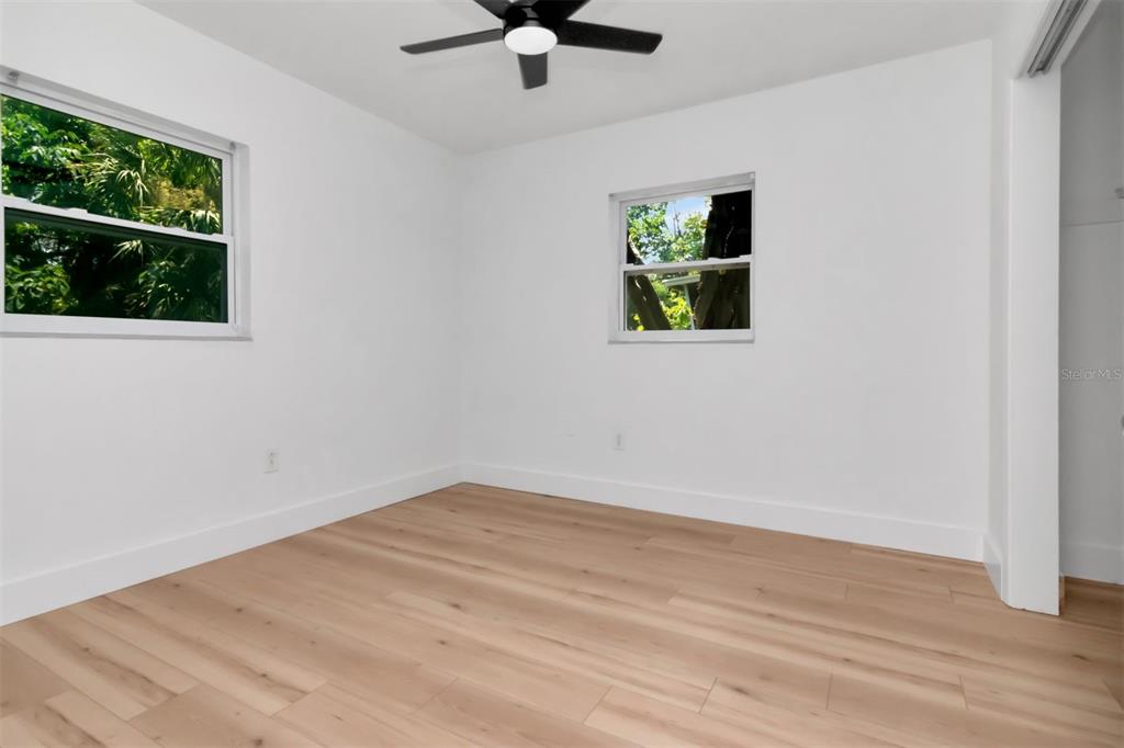 7148 Ramor Lane New Port Richey, FL 34653 - Photo 20 of 26 a view of empty room with wooden floor and fan