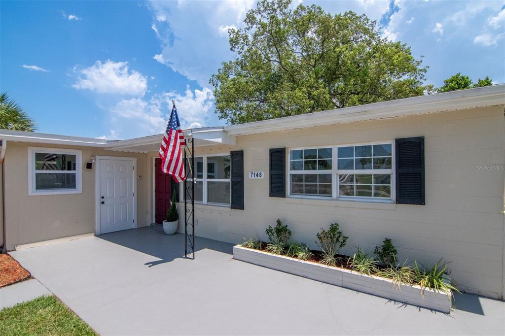 7148 Ramor Lane New Port Richey, FL 34653 - Photo 2 of 26 front view of a house with a yard