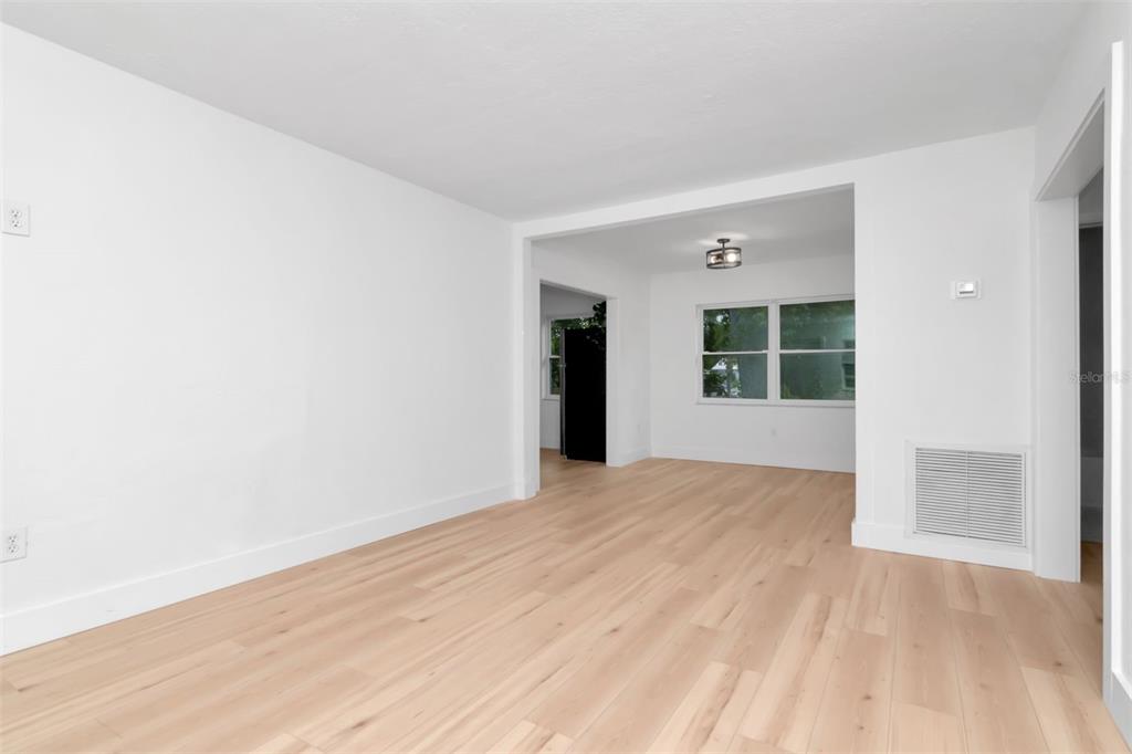 7148 Ramor Lane New Port Richey, FL 34653 - Photo 10 of 26 a view of an empty room with wooden floor and a window