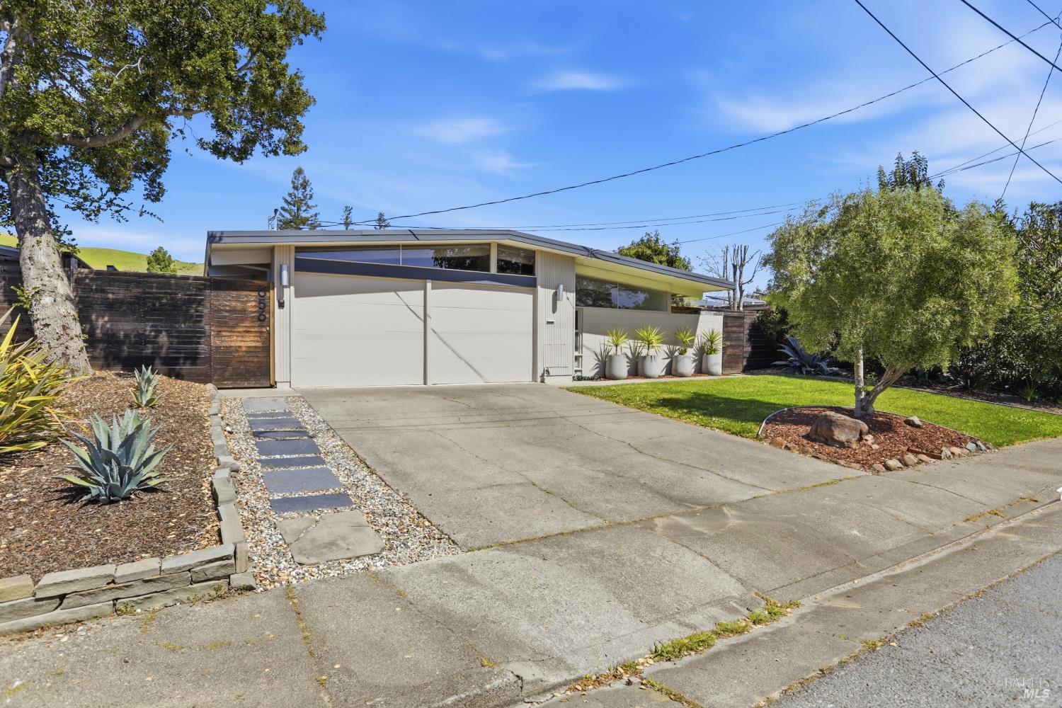 656 Bamboo Terrace San Rafael, CA 94903 - Photo 2 of 26 a front view of a house with a yard and garage