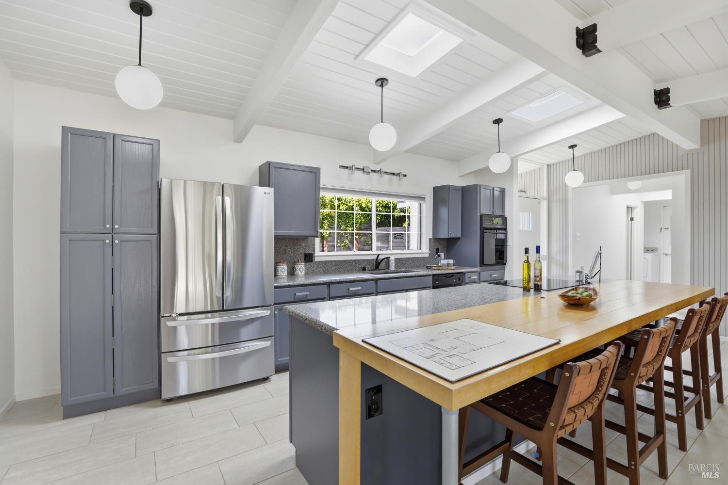 656 Bamboo Terrace San Rafael, CA 94903 - Photo 10 of 26 a kitchen with kitchen island a large counter top space appliances and a chandelier