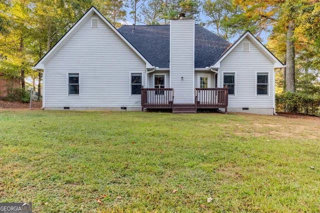 a view of a house with a yard and sitting area
