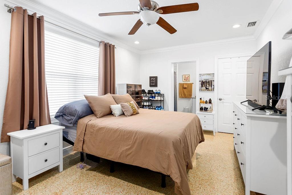 2909 West Dewey Street Tampa, FL 33607 - Photo 11 of 25 a bedroom with a bed and a flat tv screen on dresser