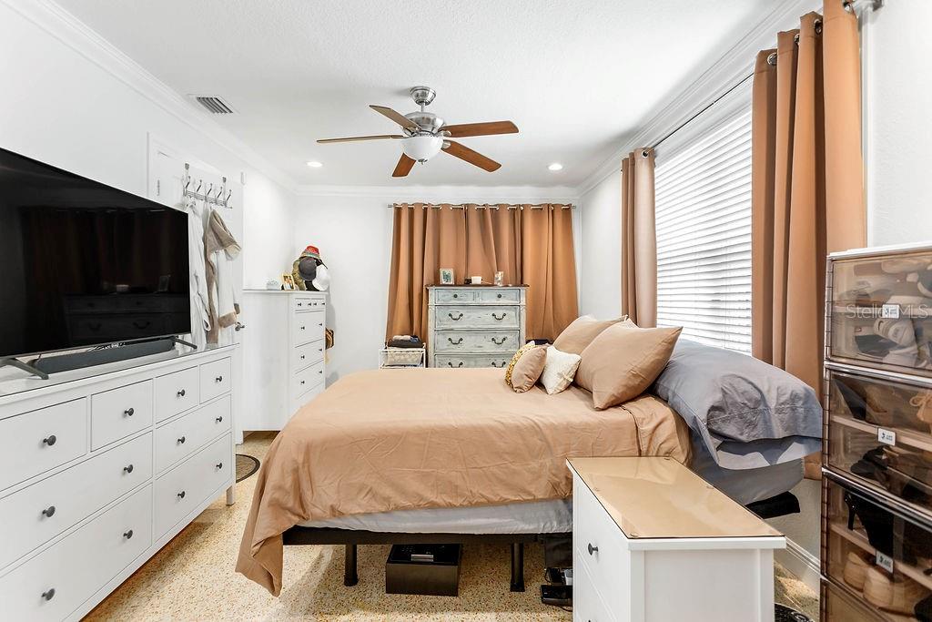 2909 West Dewey Street Tampa, FL 33607 - Photo 12 of 25 a bedroom with a bed and a flat screen tv