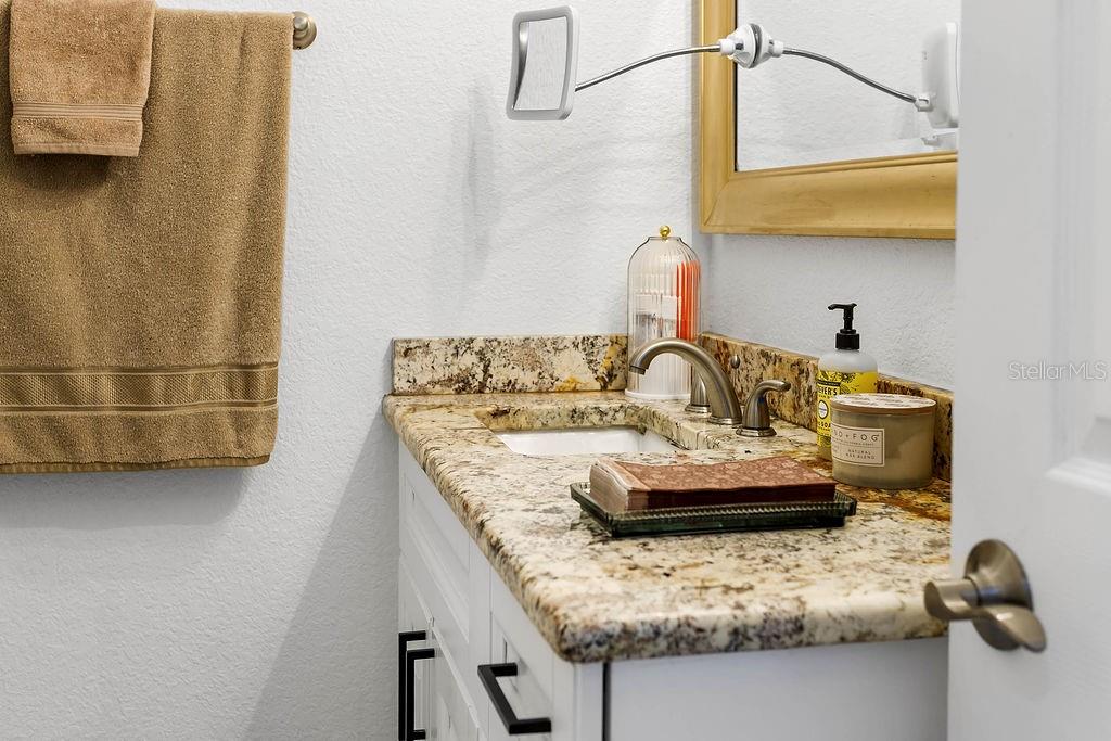 2909 West Dewey Street Tampa, FL 33607 - Photo 14 of 25 a bathroom with a granite countertop sink and a mirror