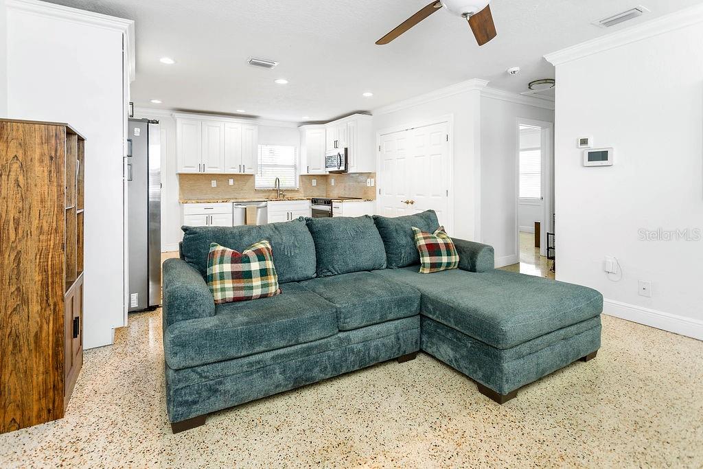 2909 West Dewey Street Tampa, FL 33607 - Photo 4 of 25 a living room with a couches and kitchen view with wooden floor