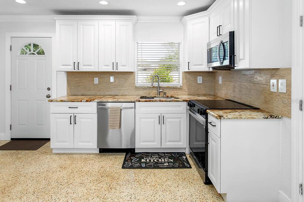 2909 West Dewey Street Tampa, FL 33607 - Photo 8 of 25 a kitchen with a sink stove and cabinets
