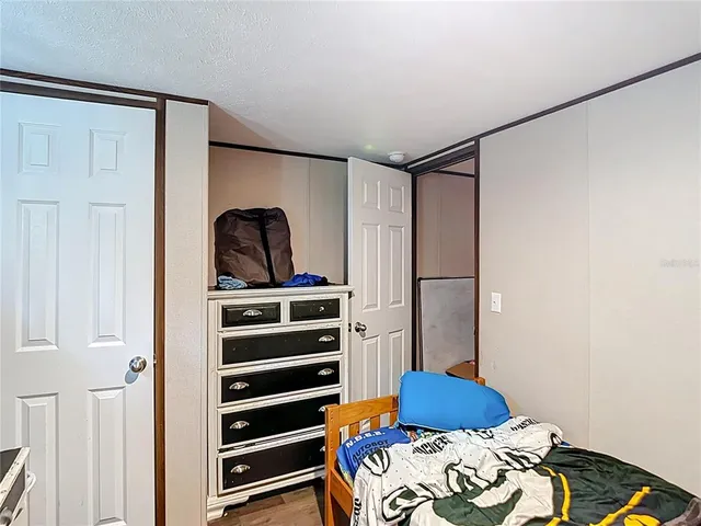 a bedroom with a bed and a closet