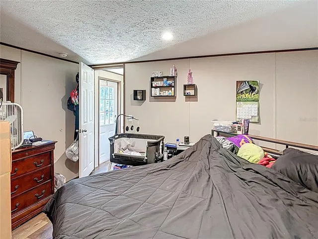 a bedroom with a bed and a dresser