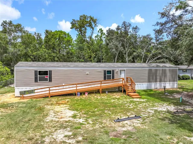 a backyard of a house with table and chairs