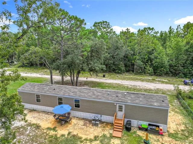 a view of a backyard with sitting area