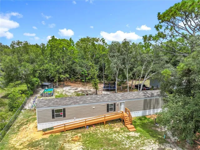 a view of a chairs and table in the backyard