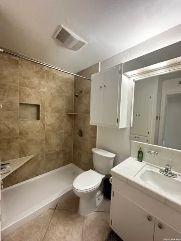 a bathroom with a toilet sink and shower