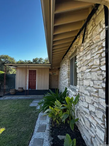 a backyard of a house with table and chairs