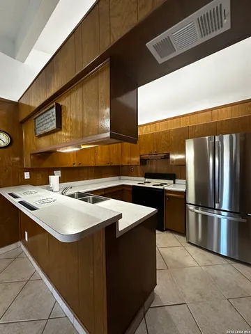 a kitchen that has a sink and a stove