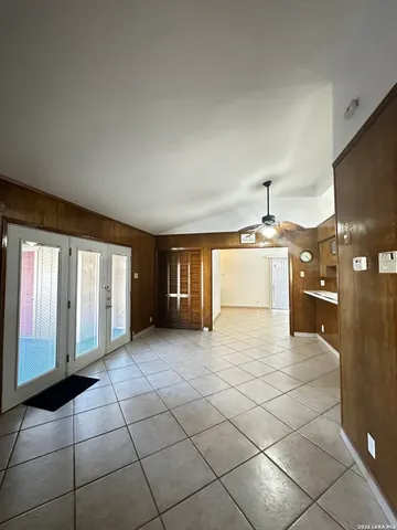 a view of hallway with a window and chandelier