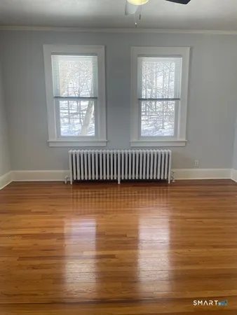 a view of an empty room with wooden floor