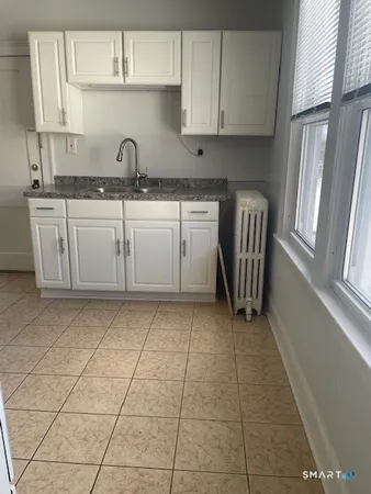 a kitchen with a sink a stove and cabinets