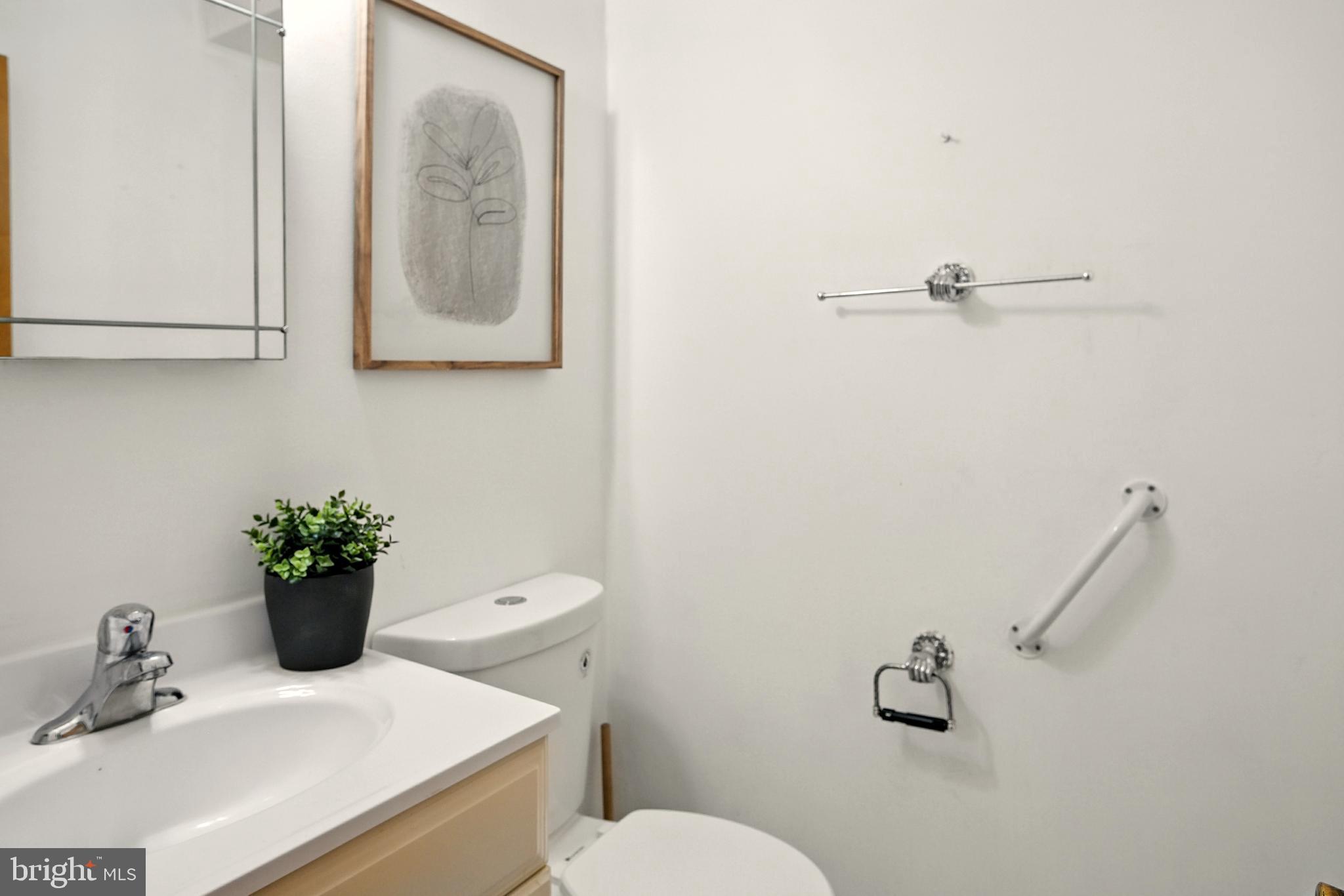 364 South Rolling Road Springfield, PA 19064 - Photo 18 of 37 a bathroom with a toilet sink and mirror