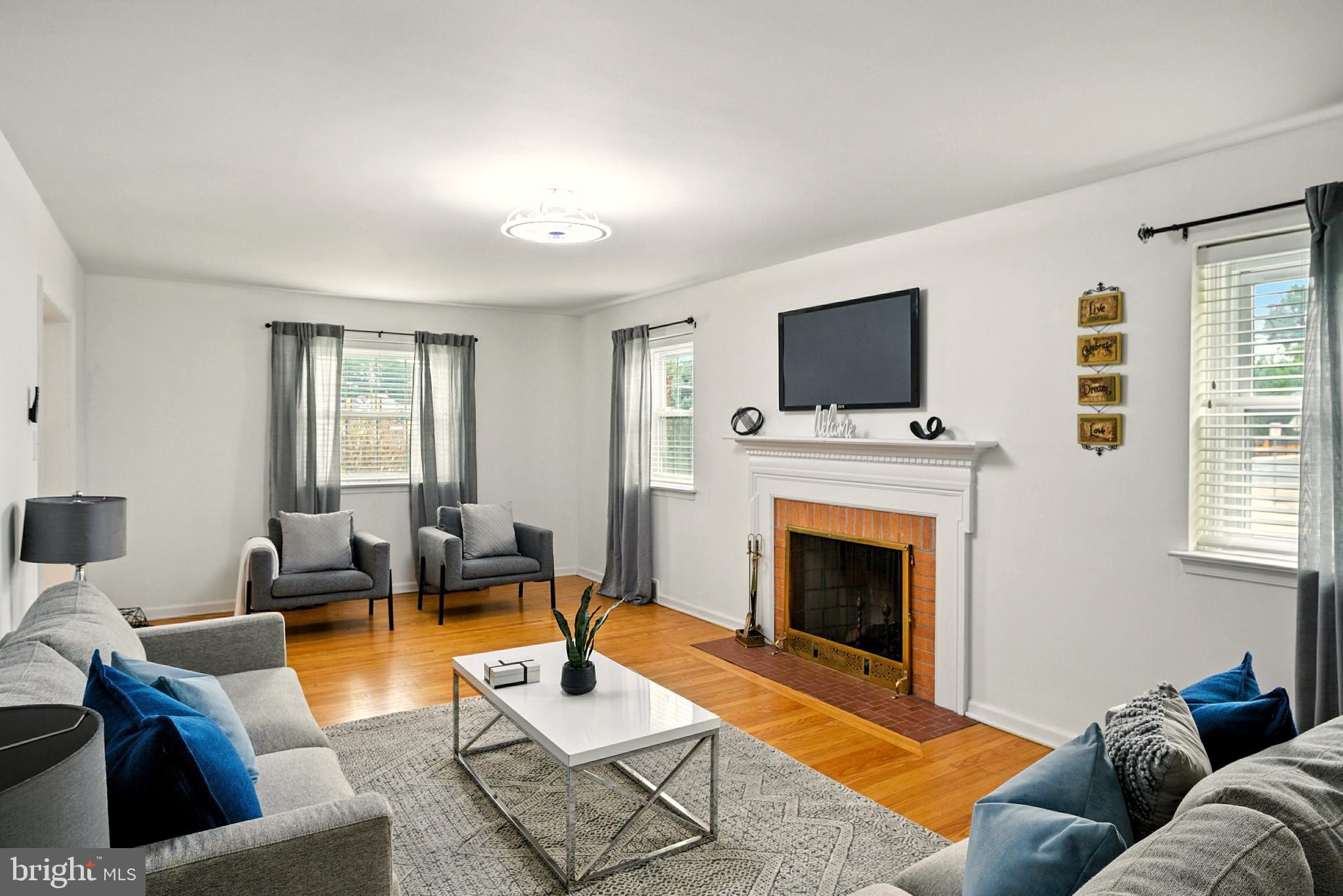 364 South Rolling Road Springfield, PA 19064 - Photo 6 of 37 a living room with furniture a fireplace and a flat screen tv
