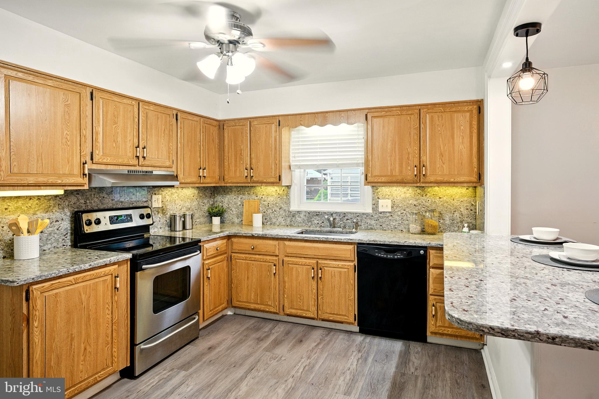 364 South Rolling Road Springfield, PA 19064 - Photo 9 of 37 a kitchen with stainless steel appliances granite countertop a stove a sink and a refrigerator