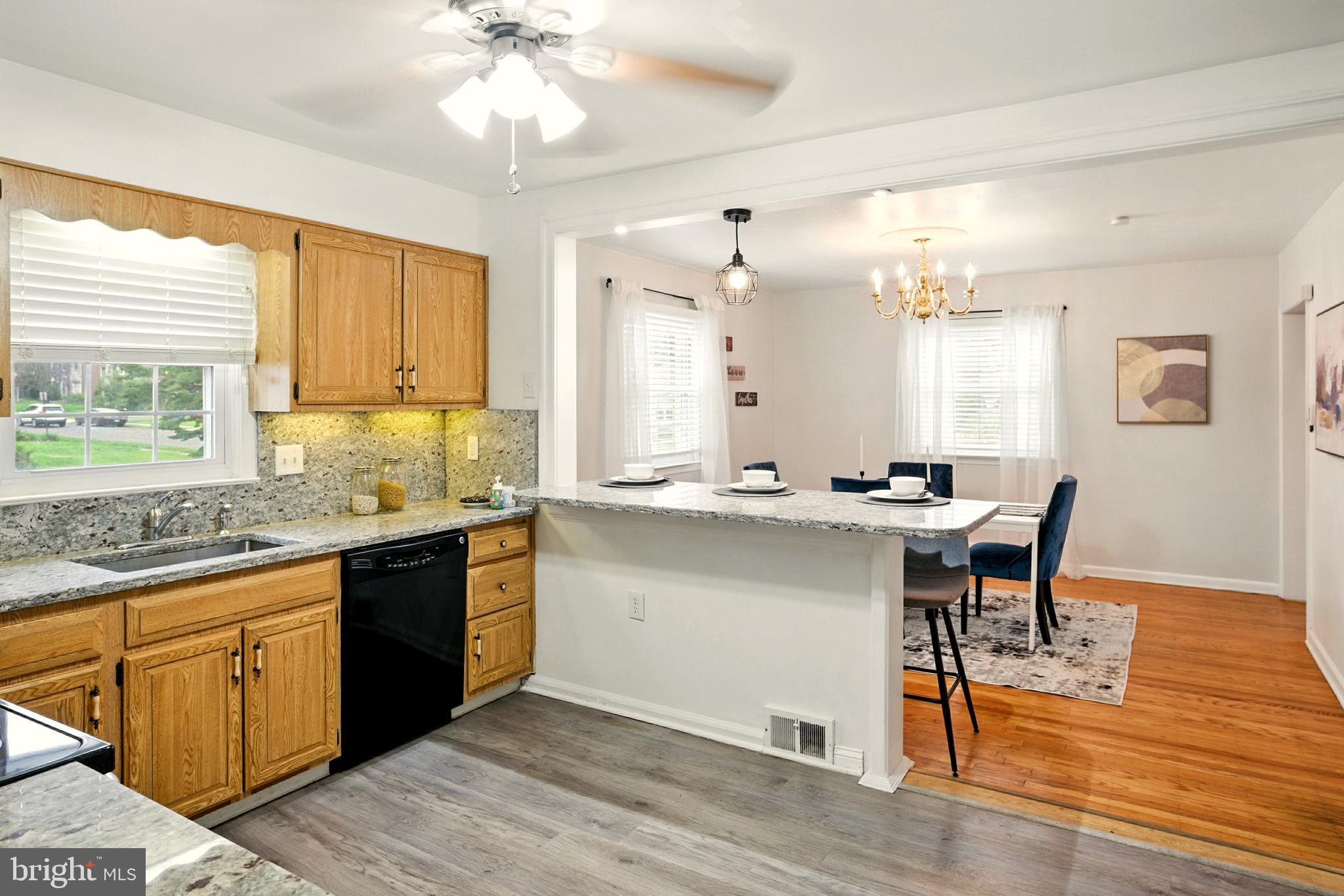 364 South Rolling Road Springfield, PA 19064 - Photo 10 of 37 a kitchen with stainless steel appliances granite countertop a sink a stove a dining table and chairs