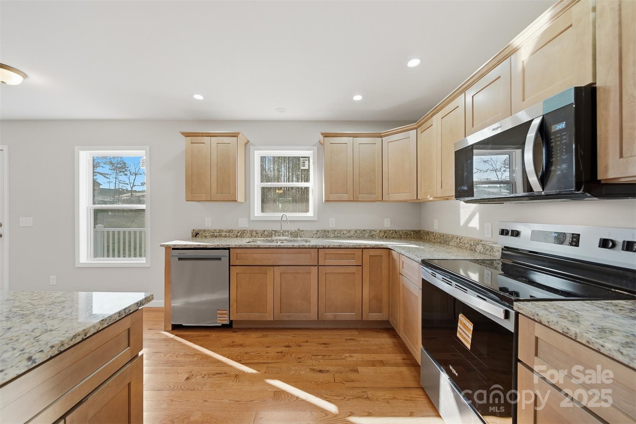 4951 Grace Chapel Road Granite Falls, NC 28630 - Photo 12 of 38 a kitchen with stainless steel appliances granite countertop a stove a sink and a microwave