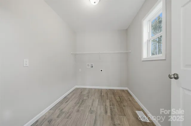a view of a room with wooden floor and windows