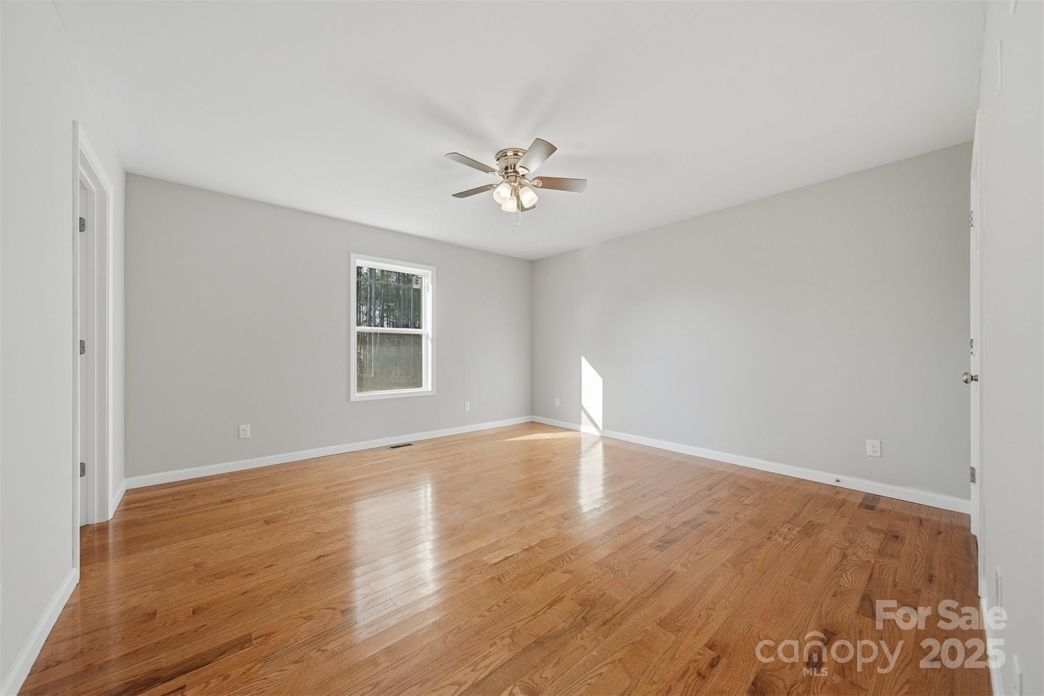 4951 Grace Chapel Road Granite Falls, NC 28630 - Photo 16 of 38 a view of an empty room with window and wooden floor