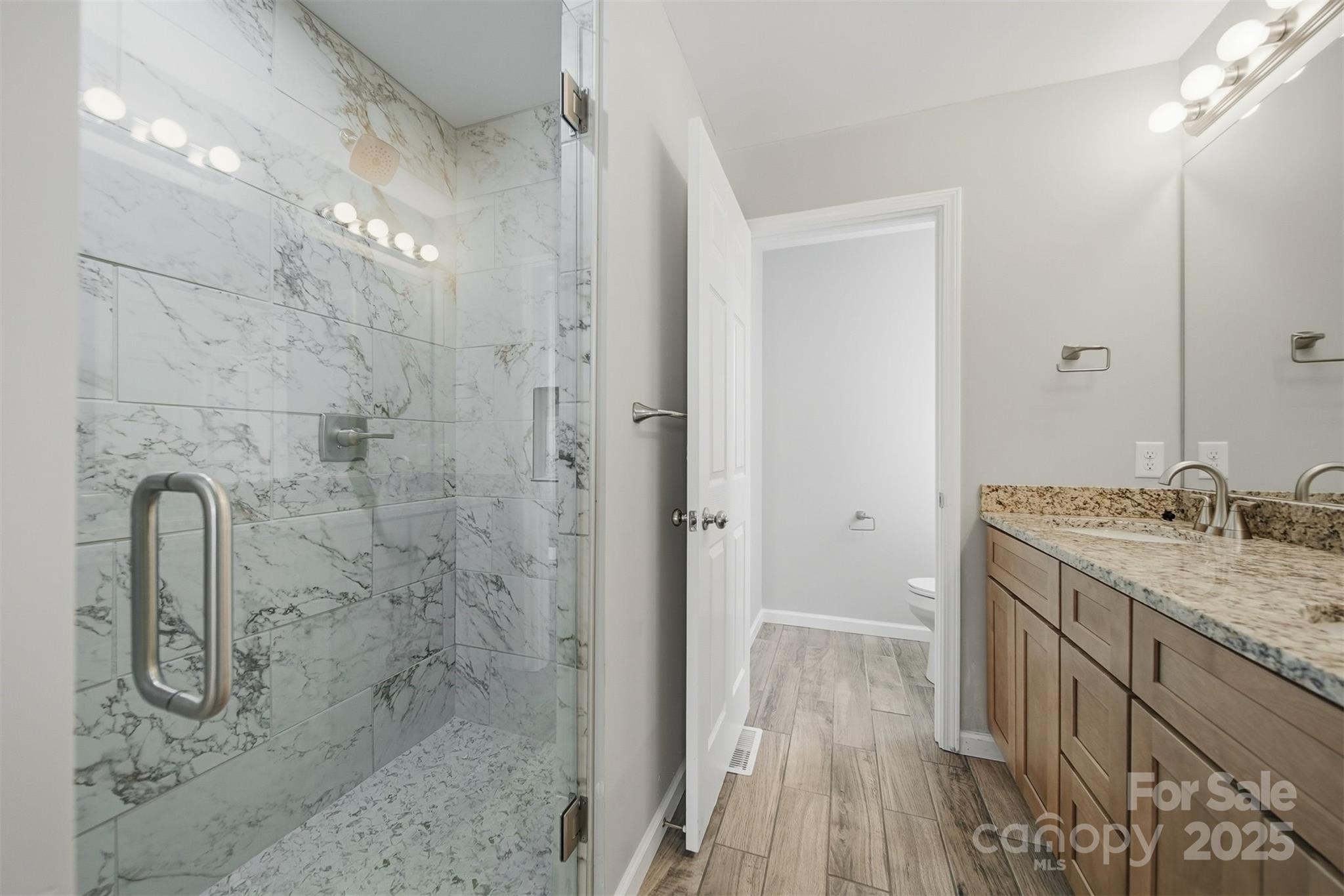 4951 Grace Chapel Road Granite Falls, NC 28630 - Photo 21 of 38 a bathroom with a granite countertop sink a toilet and shower