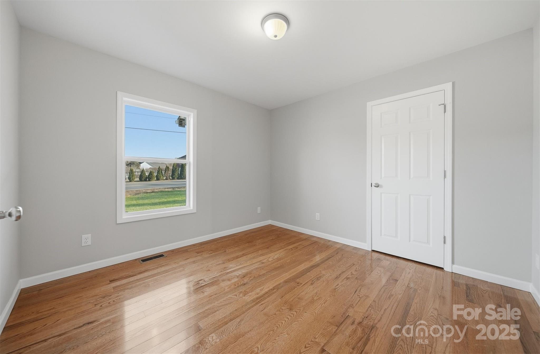 4951 Grace Chapel Road Granite Falls, NC 28630 - Photo 24 of 38 a view of an empty room with wooden floor and a window