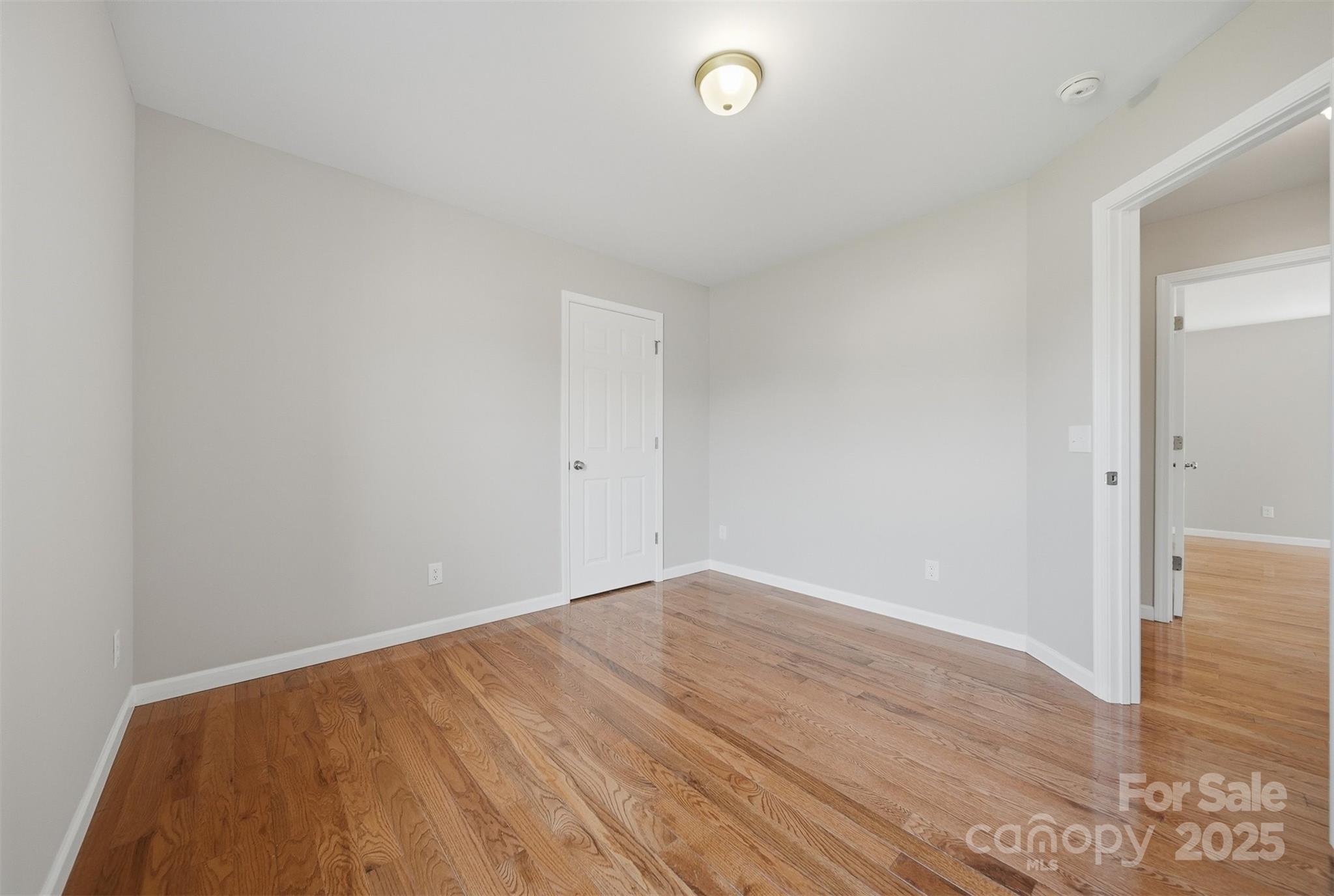4951 Grace Chapel Road Granite Falls, NC 28630 - Photo 25 of 38 an empty room with wooden floor and windows