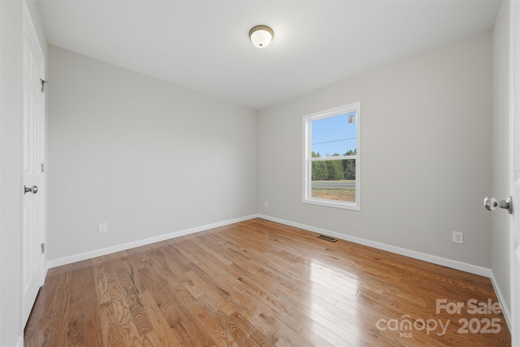 4951 Grace Chapel Road Granite Falls, NC 28630 - Photo 27 of 38 a view of an empty room with wooden floor and a window