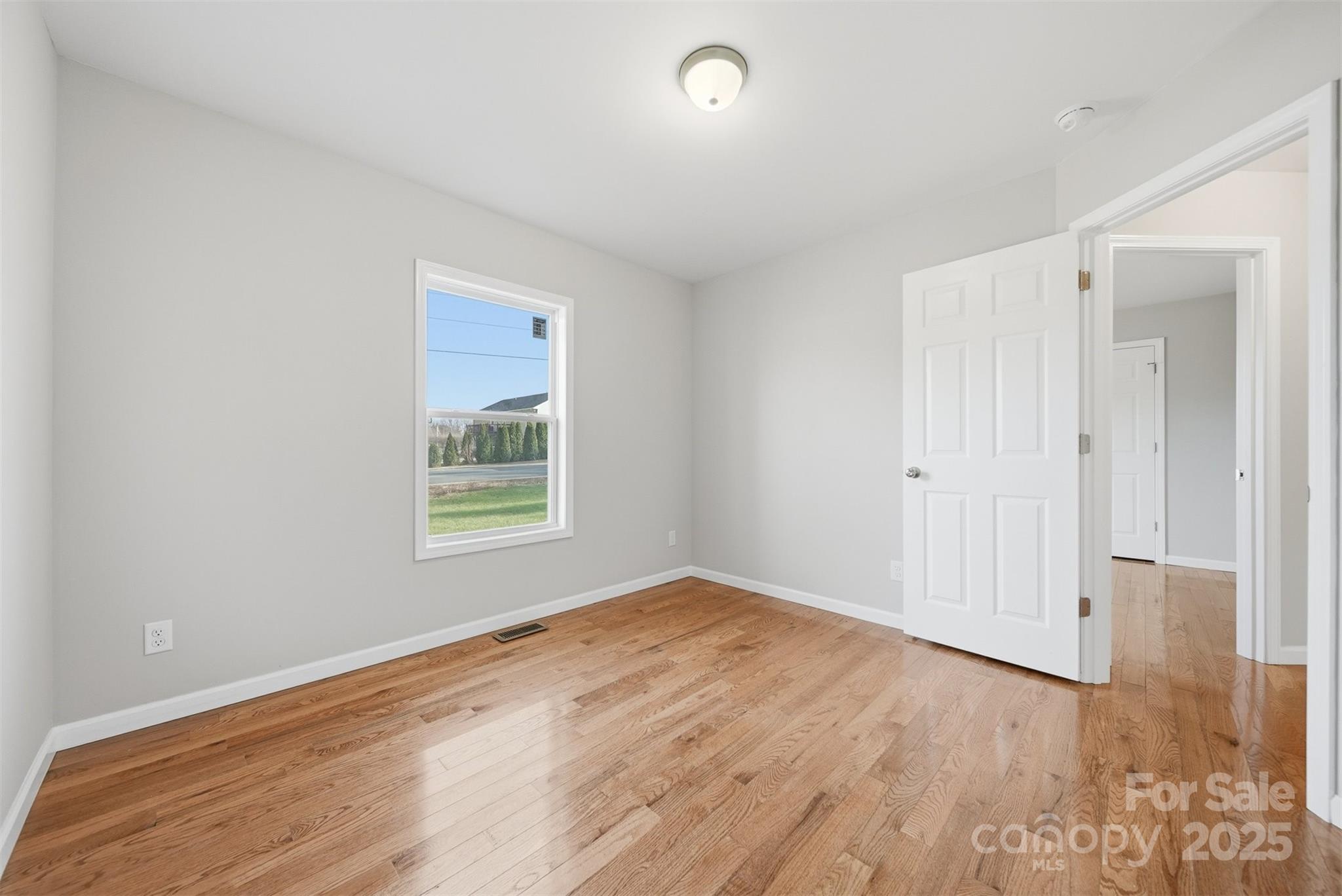4951 Grace Chapel Road Granite Falls, NC 28630 - Photo 29 of 38 an empty room with wooden floor and windows