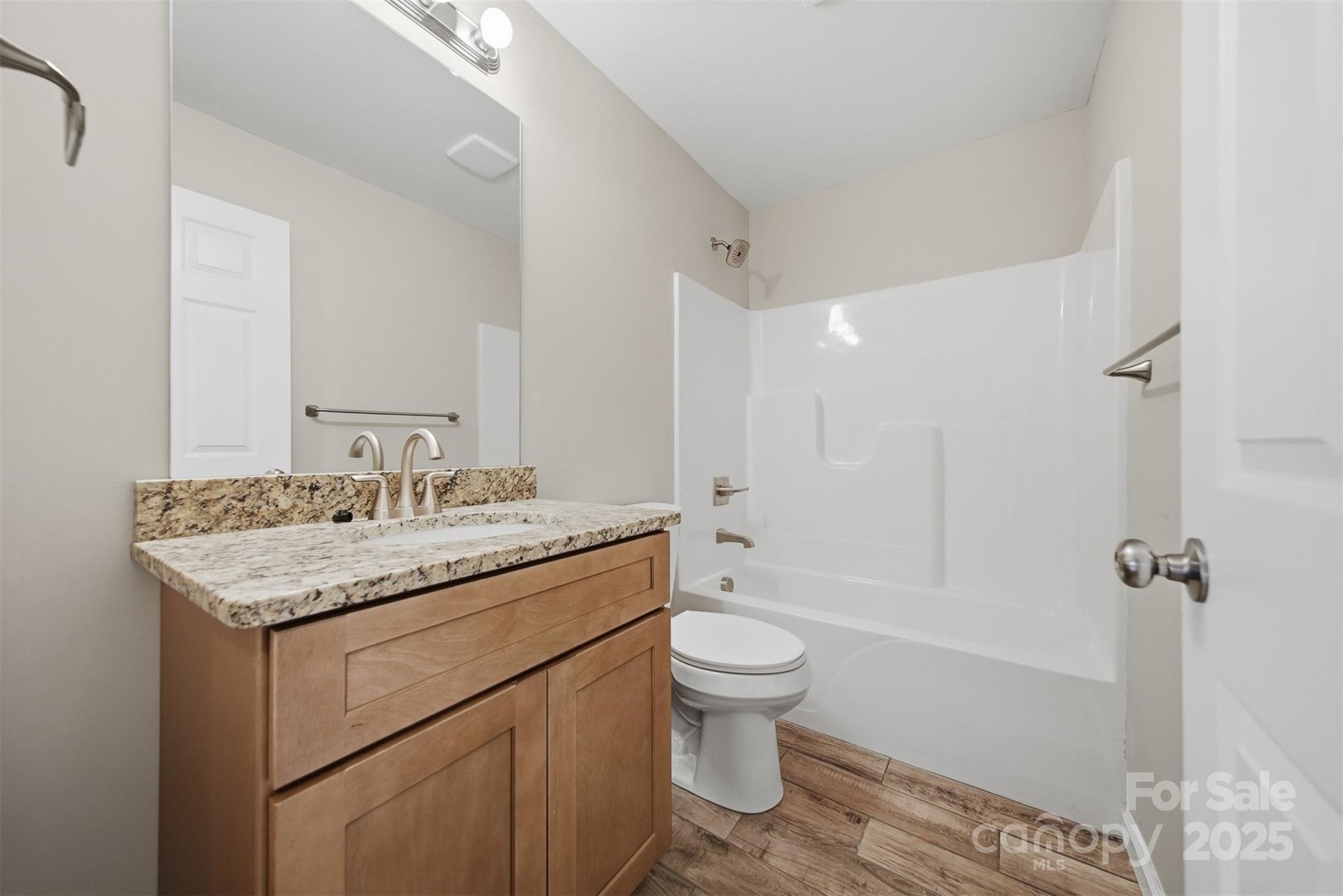 4951 Grace Chapel Road Granite Falls, NC 28630 - Photo 30 of 38 a bathroom with a granite countertop sink toilet and shower