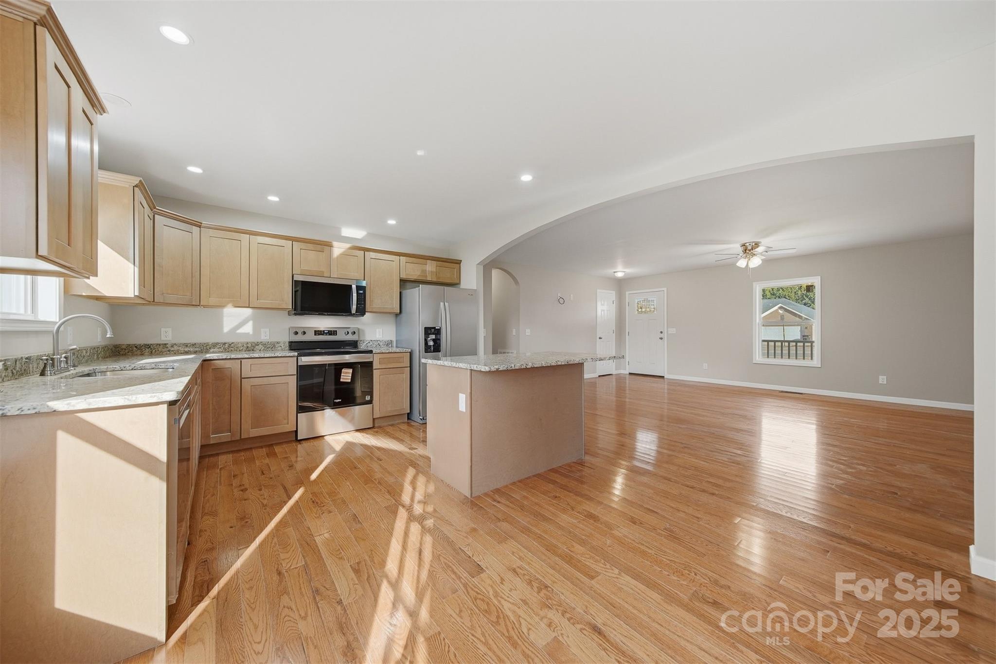 4951 Grace Chapel Road Granite Falls, NC 28630 - Photo 9 of 38 a kitchen with granite countertop a stove top oven and cabinets