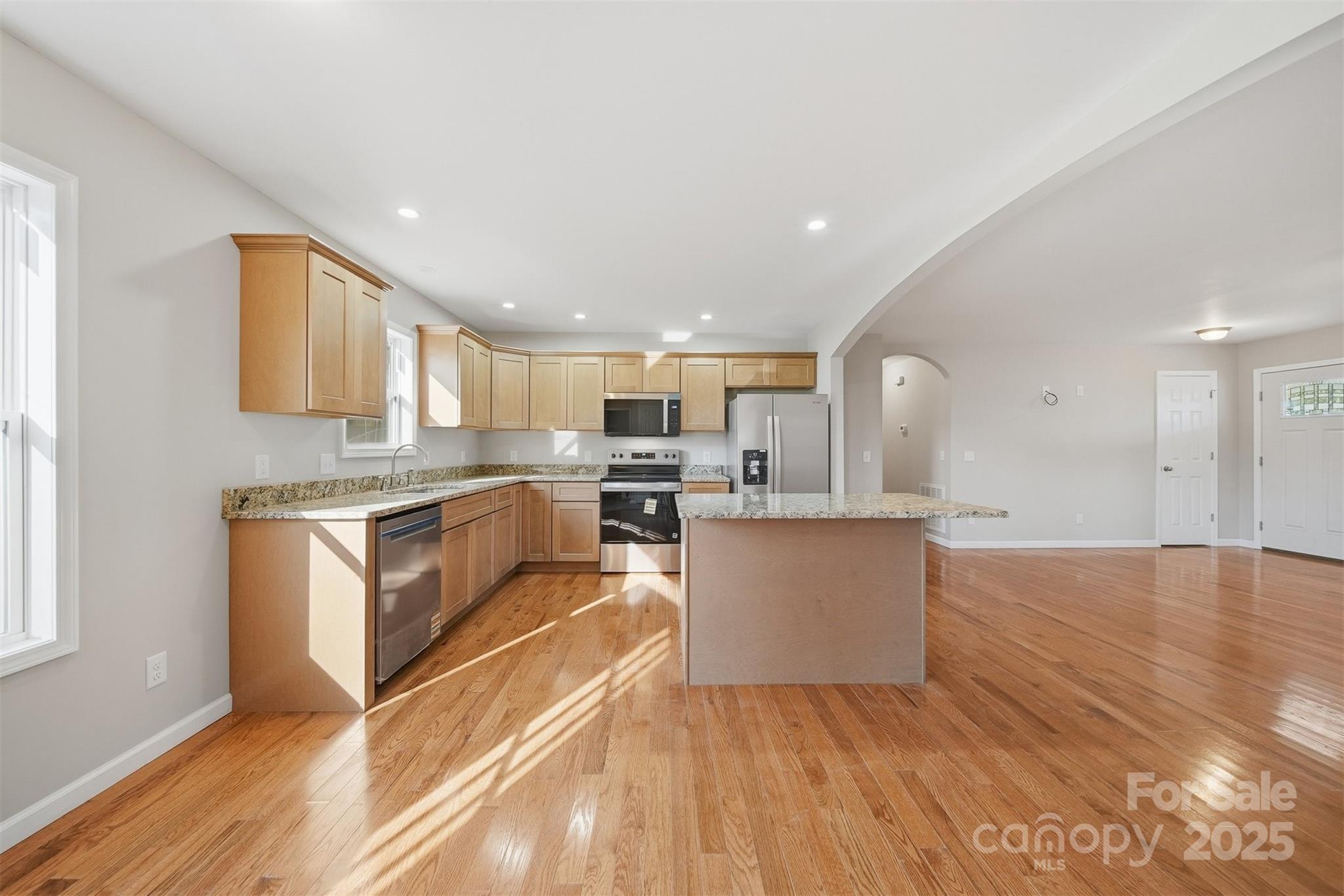 4951 Grace Chapel Road Granite Falls, NC 28630 - Photo 10 of 38 a kitchen with granite countertop a stove top oven and cabinets