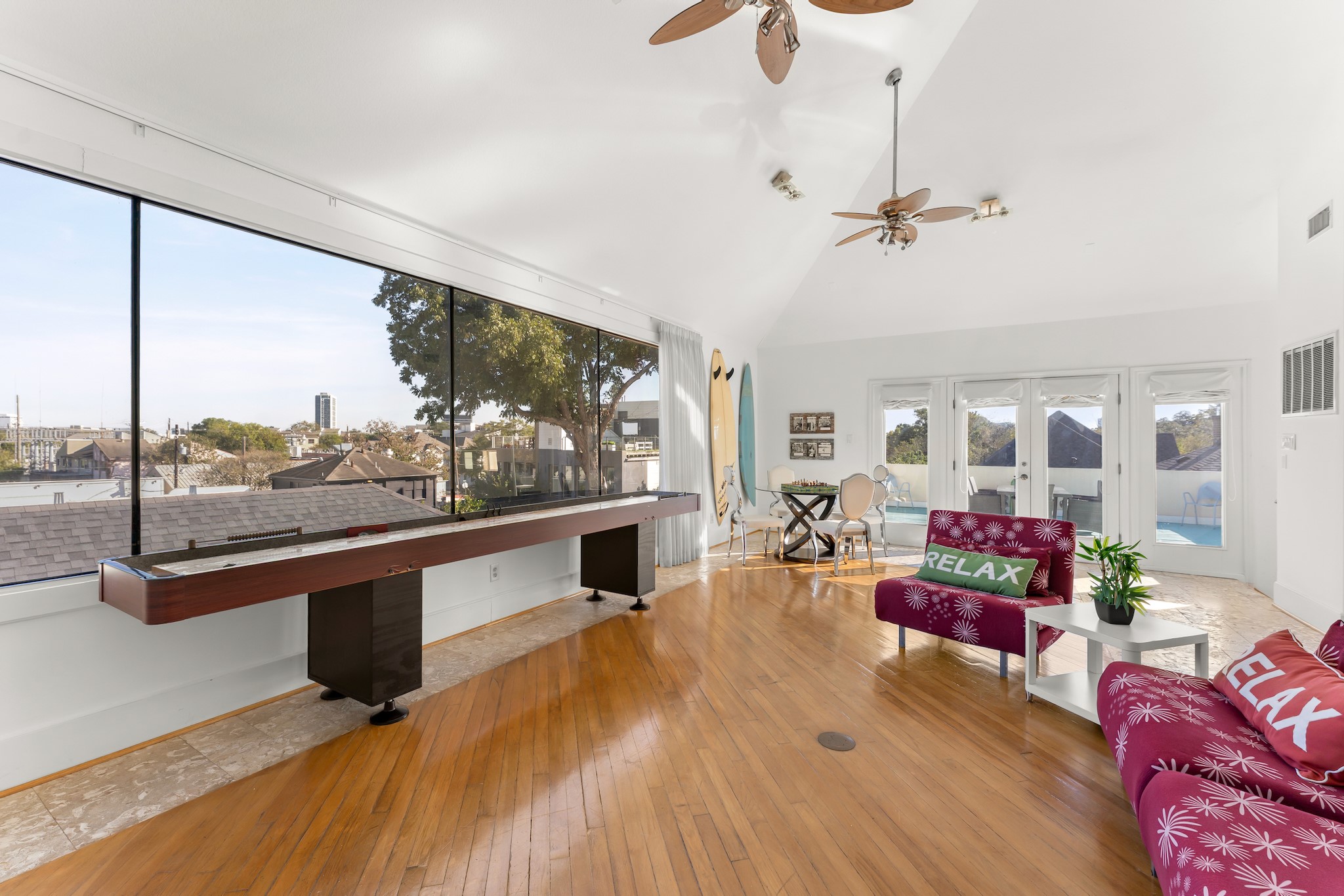 315 Fairview Street, Unit A Houston, TX 77006 - Photo 13 of 35 a living room with furniture a chandelier and a flat screen tv